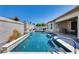 Backyard featuring a pool with a waterfall feature, travertine pavers and artificial turf at 8712 W Sequoia Dr, Peoria, AZ 85382