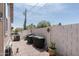 Spacious backyard with gravel, potted plants, a tall block wall and a barbecue at 9333 E University Dr # 194, Mesa, AZ 85207