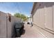 Side view of a backyard with gravel, potted plants, and a barbecue at 9333 E University Dr # 194, Mesa, AZ 85207