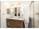 Bathroom featuring double sinks, granite countertops, and a glass-enclosed shower at 9333 E University Dr # 194, Mesa, AZ 85207