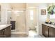 Bright bathroom featuring a tiled shower with glass door and neutral colored walls at 9333 E University Dr # 194, Mesa, AZ 85207