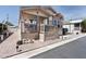 Inviting single-story home with quaint front porch and desert-inspired landscaping at 9333 E University Dr # 194, Mesa, AZ 85207