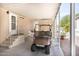 A covered car port with a golf cart and a doorway with stairs to the front door at 9333 E University Dr # 194, Mesa, AZ 85207