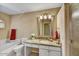 Bright bathroom with a granite countertop vanity, and a large tub at 9717 W Marco Polo Rd, Peoria, AZ 85382