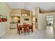 Inviting dining area with a wet bar, pendant lighting, and view to outside patio at 9717 W Marco Polo Rd, Peoria, AZ 85382