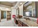 Spa-like main bathroom with granite countertops, dual sinks, and a walk-in shower for a luxurious experience at 9717 W Marco Polo Rd, Peoria, AZ 85382
