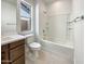 Clean bathroom with a single sink vanity, a toilet, and a shower-tub combo at 9845 E Tahoe Ave, Mesa, AZ 85212