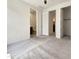 Spacious carpeted bedroom with neutral walls and trim; note the dual doorways and interior doors at 9845 E Tahoe Ave, Mesa, AZ 85212