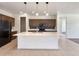 An open concept kitchen features a large island, stainless appliances, and attractive dark cabinetry at 9845 E Tahoe Ave, Mesa, AZ 85212
