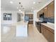 Modern kitchen with stainless steel appliances, an island, and open to the dining area at 9845 E Tahoe Ave, Mesa, AZ 85212