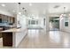 Open-concept kitchen with a center island and an adjacent living room with ample light at 9845 E Tahoe Ave, Mesa, AZ 85212
