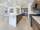 The kitchen showcases a center island, stainless appliances, attractive pendant lighting, and ample cabinet space at 9845 E Tahoe Ave, Mesa, AZ 85212