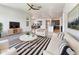 Bright and airy living room with stylish decor and a ceiling fan at 9845 E Tahoe Ave, Mesa, AZ 85212