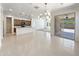 Open concept living space with a view to the kitchen, outdoor patio, and neutral color palette at 9845 E Tahoe Ave, Mesa, AZ 85212