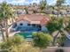 Stunning aerial view of a home featuring a private pool, patio, and beautiful landscaping with palm trees at 10248 E San Salvador Dr, Scottsdale, AZ 85258