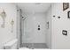 Modern bathroom with marble tiled shower, black fixtures and patterned floor at 10248 E San Salvador Dr, Scottsdale, AZ 85258