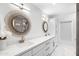 Bright bathroom featuring a white vanity with double sinks, quartz countertop, and decorative lighting at 10248 E San Salvador Dr, Scottsdale, AZ 85258