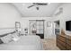 Modern bedroom with a comfortable bed, stylish sliding bathroom door, and bright natural light at 10248 E San Salvador Dr, Scottsdale, AZ 85258