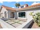 House exterior featuring a tiled roof, desert plants and a neatly designed entryway at 10248 E San Salvador Dr, Scottsdale, AZ 85258