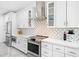Well-equipped kitchen featuring white cabinetry, stainless steel appliances, and modern backsplash at 10248 E San Salvador Dr, Scottsdale, AZ 85258