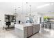 Open kitchen and dining area with a large island, stainless steel appliances, and backyard views at 10248 E San Salvador Dr, Scottsdale, AZ 85258