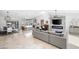 Bright, open-concept living room flowing into a modern kitchen with an island and stainless appliances at 10248 E San Salvador Dr, Scottsdale, AZ 85258