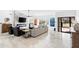 Modern living room with a marble accent wall, fireplace, and large windows with outdoor views at 10248 E San Salvador Dr, Scottsdale, AZ 85258