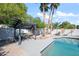Pergola next to the pool with seating area, stone landscaping and palm trees at 10248 E San Salvador Dr, Scottsdale, AZ 85258