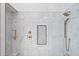 Luxurious walk-in shower with white marble, black and white tile accents, and bronze shower fixtures at 10248 E San Salvador Dr, Scottsdale, AZ 85258
