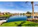 Lush backyard with a waterfront view, boat dock, and mature landscaping at 10390 E Lakeview Dr # 204, Scottsdale, AZ 85258
