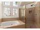 Bathroom showcasing a tub with windows, and a shower stall with glass door at 10390 E Lakeview Dr # 204, Scottsdale, AZ 85258
