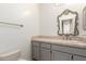 Powder room with toilet, sink, drawers, and vanity mirror at 10390 E Lakeview Dr # 204, Scottsdale, AZ 85258
