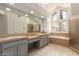Spacious bathroom featuring double sinks, a large mirror, and a separate shower and tub at 10390 E Lakeview Dr # 204, Scottsdale, AZ 85258
