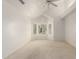 Bright bedroom featuring a ceiling fan, vaulted ceiling and large windows with shutters at 10390 E Lakeview Dr # 204, Scottsdale, AZ 85258