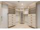 Walk-in closet with custom shelving and drawers offers ample storage at 10390 E Lakeview Dr # 204, Scottsdale, AZ 85258