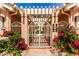 The front decorative gates are accented with green shrubbery and flowers at 10390 E Lakeview Dr # 204, Scottsdale, AZ 85258