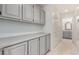 Hallway with built-in cabinets and a view into the bathroom with a large mirror at 10390 E Lakeview Dr # 204, Scottsdale, AZ 85258