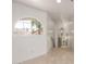 Hallway with tiled floors, an arched window, and a decorative mirror at 10390 E Lakeview Dr # 204, Scottsdale, AZ 85258