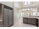 Bright kitchen with tile floors, tile backsplash, and stainless steel appliances at 10390 E Lakeview Dr # 204, Scottsdale, AZ 85258