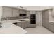 Bright kitchen with tile floors, tile backsplash, and white countertops at 10390 E Lakeview Dr # 204, Scottsdale, AZ 85258