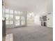 Spacious living room with high ceilings, chandelier, built in bar, and french doors to outdoor space at 10390 E Lakeview Dr # 204, Scottsdale, AZ 85258