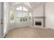 Bright living room with wood floors, large windows with shutters, and a cozy fireplace at 10390 E Lakeview Dr # 204, Scottsdale, AZ 85258