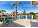 Waterfront patio with glass railings, a boat, and views of lush landscaping at 10390 E Lakeview Dr # 204, Scottsdale, AZ 85258