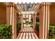 Inviting walkway with pergola showing the well-maintained front yard at 10390 E Lakeview Dr # 204, Scottsdale, AZ 85258
