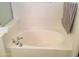 Relaxing soaking tub with sleek fixtures and a cozy atmosphere at 10489 S 182Nd Dr, Goodyear, AZ 85338