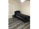 Simple bedroom with wood-look flooring, neutral walls, and a comfortable single bed at 10489 S 182Nd Dr, Goodyear, AZ 85338