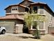 Stylish two-story home features a terracotta roof, stone accents, and a welcoming front yard with desert landscaping at 10489 S 182Nd Dr, Goodyear, AZ 85338