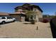 Charming two-story home with a low-maintenance desert landscape, long driveway, and attached two-car garage at 10489 S 182Nd Dr, Goodyear, AZ 85338
