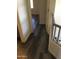 Upstairs hallway with wood-look flooring, connecting various rooms in the home at 10489 S 182Nd Dr, Goodyear, AZ 85338
