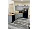 Kitchen with gray cabinets and black appliances at 10489 S 182Nd Dr, Goodyear, AZ 85338